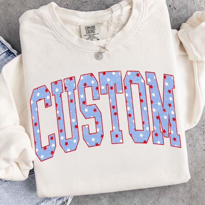 Patriotic 4th of July varsity letter design with distressed stars.