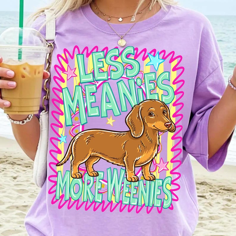 Retro Dachshund 'Less Meanies More Weenies' T-shirt design in vibrant teal and hot pink, Y2K style.