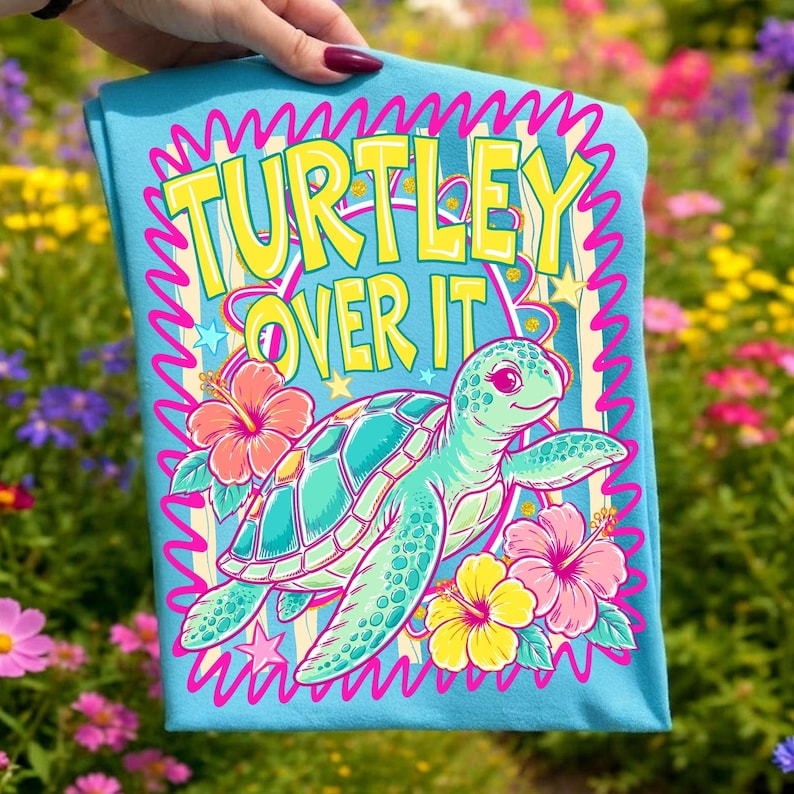 A vibrant 'Turtley Over It' sea turtle sublimation design with neon pink and teal hibiscus flowers, perfect for summer beach shirts.