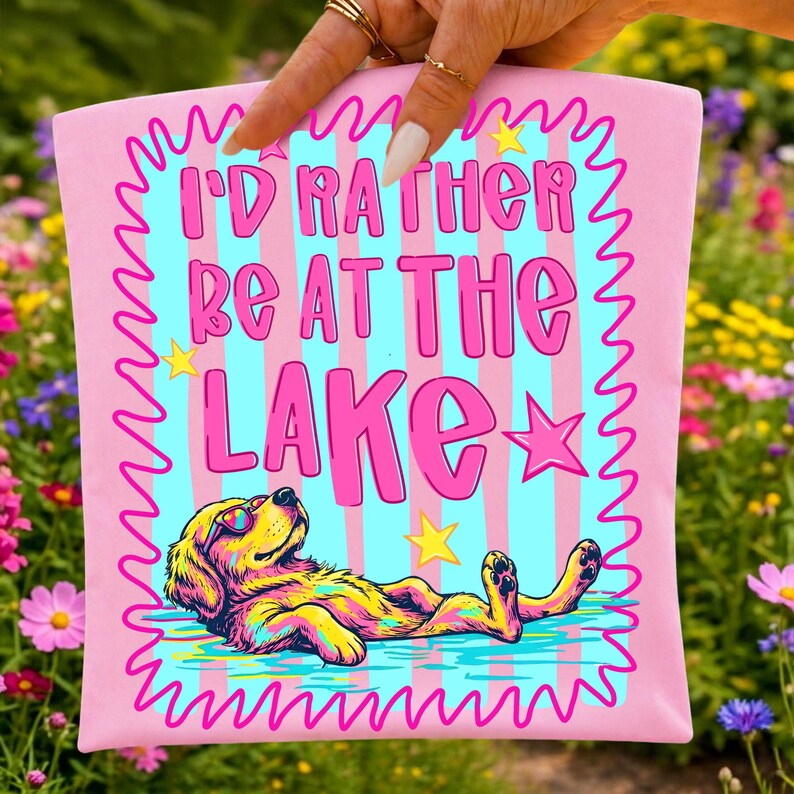 Humorous floating dog graphic with "I'd Rather Be At The Lake" text.