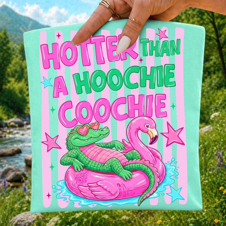 Vibrant 'Hotter Than A Hoochie Coochie' coquette alligator PNG design with pink bow on a white background, perfect for sublimation projects.