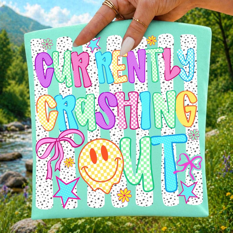 Vibrant 'Currently Crashing Out' funny teacher sublimation design with a retro Y2K smiley face and coquette bow.
