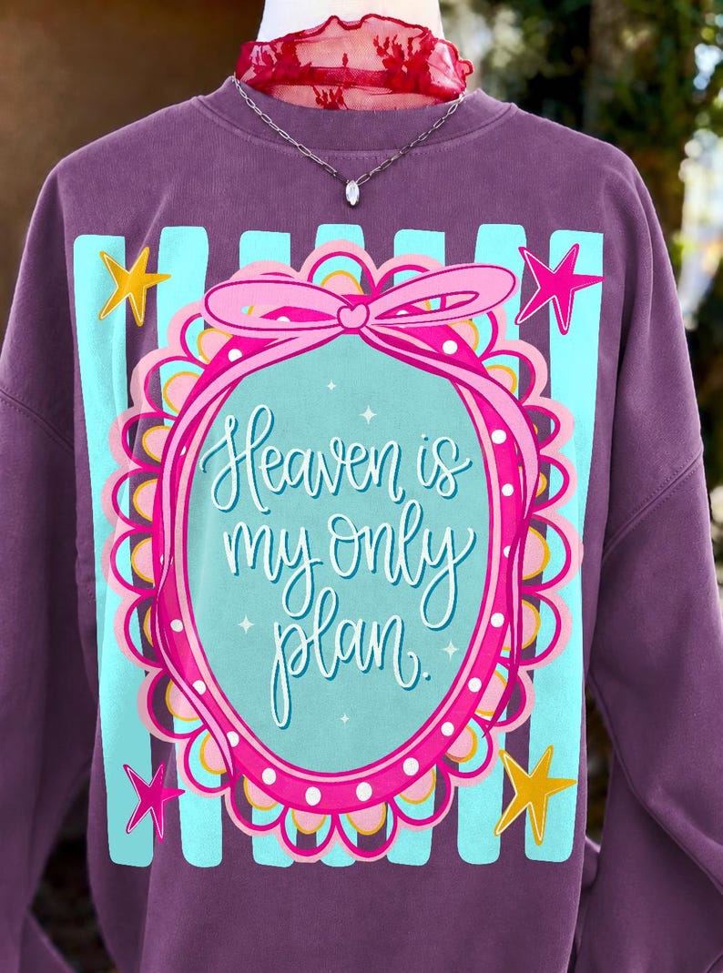 A white t-shirt mockup featuring the 'Heaven Is My Only Plan' Christian sublimation design with a pink coquette bow.